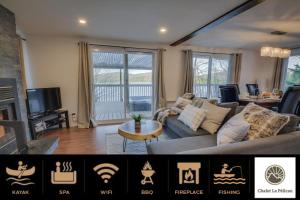a living room with a couch and a tv at Chalet Le Pélican in Lac-Superieur +44 photos