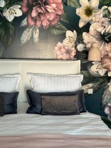 a bedroom with a flower mural on the wall at Sievershof Poolloft in Wietzendorf +46 photos