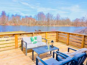 a deck with two chairs and a table with a table at Breezes Park in Acton