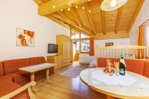 a living room with a couch and a table at Demelhof in Reit im Winkl