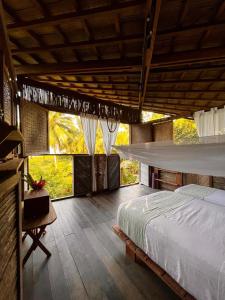 a bedroom with a bed and a large window at luzzul in Nuquí