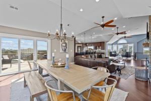 a dining room and living room with a table and chairs at 7015 - Nirvana by Resort Realty in Rodanthe
