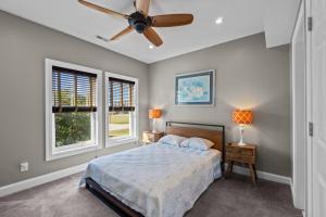 a bedroom with a bed and a ceiling fan at 7015 - Nirvana by Resort Realty in Rodanthe