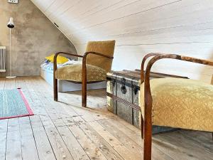 1 dormitorio con 1 cama y 1 silla en el ático en Holiday home HÖGANÄS en Höganäs