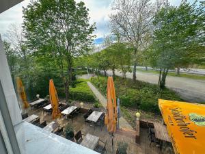 a view of a patio with tables and umbrellas at Premium Apartments Schwetzingen, Heidelberg, Speyer in Schwetzingen