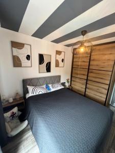 a bedroom with a blue bed and a window at Apartments Ćosić in Klenovica +45 photos