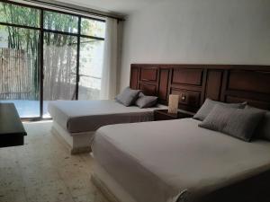 Ένα ή περισσότερα κρεβάτια σε δωμάτιο στο Quinta Edén Cuernavaca