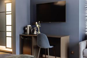 TV a/nebo společenská místnost v ubytování L'Empreinte