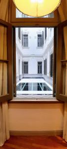 an open window with a view of a building at Esplendor by Wyndham Savoy Rosario in Rosario