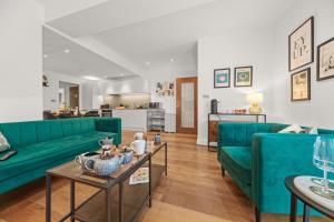 a living room with a green couch and a table at Springfield Two in Harrogate