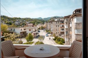 a view of a city from a window with a table at Holiday Hideout in Gjirokastër
