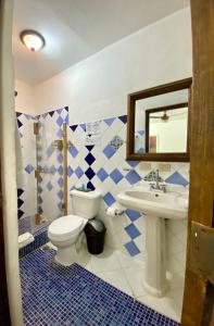 a bathroom with a toilet and a sink at Boutique Colonial House Hotel in Santo Domingo