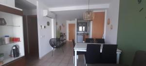 a kitchen and dining room with a table and chairs at Bellreguard Playa 5 in Bellreguart