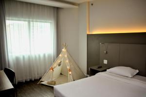 a bedroom with a bed and a tent in it at Intercity São Paulo Ibirapuera in Sao Paulo +40 photos