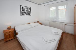 Posteľ alebo postele v izbe v ubytovaní Apartmany ZEA