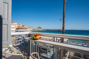 a bowl of fruit on a balcony overlooking the ocean at Window to the Aegean in Kokkari