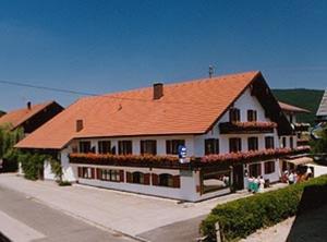 a large white building with an orange roof at Hotel Hemetsberger in Attersee am Attersee