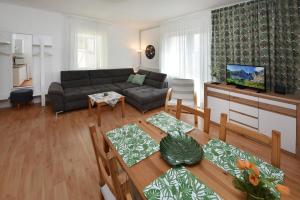 a living room with a couch and a table at Apartmany ZEA in Tatranská Lomnica