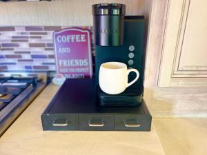 a coffee cup sitting on top of a box next to a stove at Breezes Park in Acton