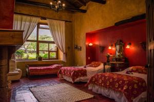 a bedroom with two beds and a window at Hacienda San Francisco in Tumbabiro