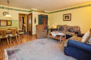 a living room with a blue couch and a table at Ferienwohnung Alex in Reit im Winkl