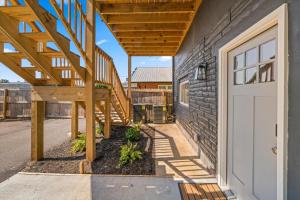 a porch with a wooden staircase next to a building at Spacious Freshly Renovated Townhome - City Side in Loudon