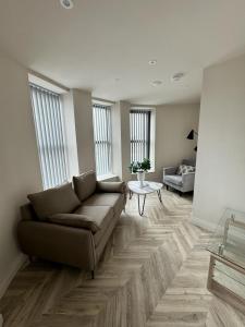 sala de estar con sofá y mesa en 2 Bedroom City Centre Penthouse en Leeds