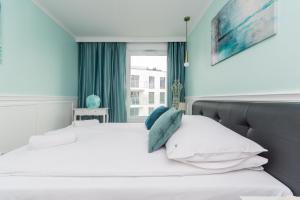a bedroom with a bed and a window at Golden Azzure by Grand Apartments in Gdańsk