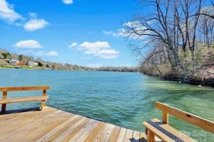 a wooden dock with a bench on top of a lake at Gracious Lookout in Hickory