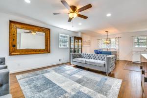 a living room with a couch and a mirror at Charming Atlanta Home with Yard 7 Mi to Downtown! in Atlanta