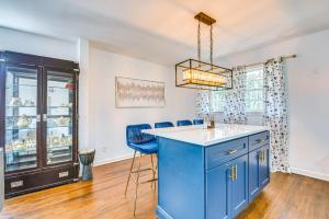 a kitchen with a blue island and blue chairs at Charming Atlanta Home with Yard 7 Mi to Downtown! in Atlanta