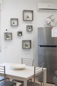 a kitchen with a table and a refrigerator at Casa BeFra Il relax che cercavi in Torre San Gennaro +33 photos