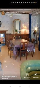 Cette chambre comprend une table, des chaises et un miroir. dans l'établissement GITE INSOLITE Le Pressoir en Touraine, à Vallières-les-Grandes