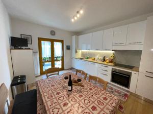 a kitchen with a table with a bottle of wine on it at Apartment Weisswand in Colle Isarco +12 photos