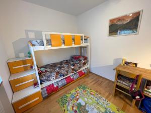a bedroom with a bunk bed and a desk at Apartment Weisswand in Colle Isarco