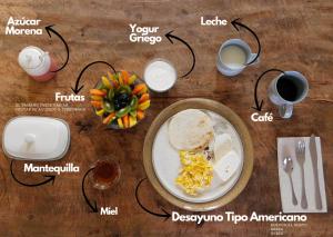a table topped with a plate of food and a table at Hostal Santa Teresita in La Merced