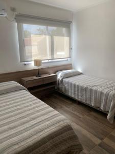 a hotel room with two beds and a window at Rio Victoria in Victoria +62 photos