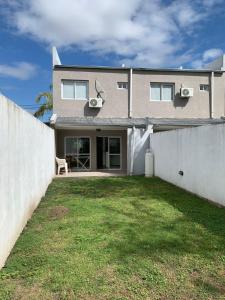 a house with a fence and a grass yard at Rio Victoria in Victoria