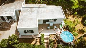 an aerial view of a house with a swimming pool at Ellafos Traditional Living in Loúkhiou