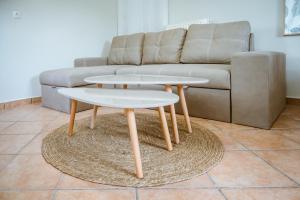 a living room with two tables and a couch at Ellafos Traditional Living in Loúkhiou