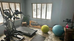a room with a gym with a treadmill and exercise balls at Maso Corto Alpine Adventure in Maso Corto