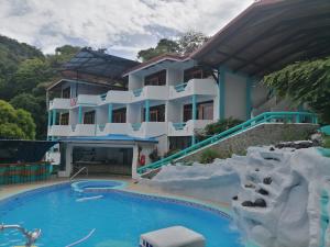 a hotel with a water slide in front of it at Hotel Planeta Sano in Manuel Antonio