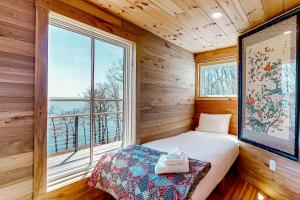 a small bedroom with a bed and a window at Cottage on the Coast in Rockport