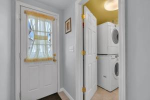 a white laundry room with a washer and dryer at Short Walk to the Beach! in Keansburg
