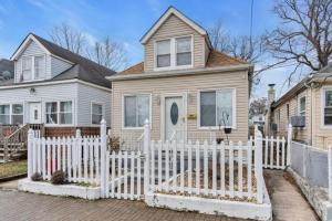 a white fence in front of a house at Short Walk to the Beach! in Keansburg