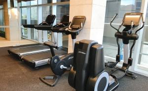 a row of exercise bikes in a gym at A Bright & Modern CBD Apt Next to Southern Cross in Melbourne
