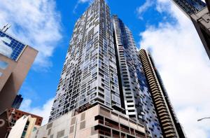 a tall skyscraperraper in a city at A Bright & Modern CBD Apt Next to Southern Cross in Melbourne