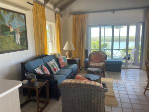 a living room with a blue couch and chairs at Sunnyside home in Savannah Sound