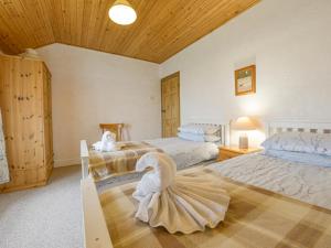 a bedroom with two beds and a swan on the floor at The Farmhouse in Penzance