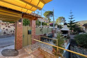 a brick house with a gate and a fence at Chalet de Carmen in Castelldefels